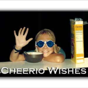 Photo of Young Girl in Swim Goggles at Counter With Cheerios Box