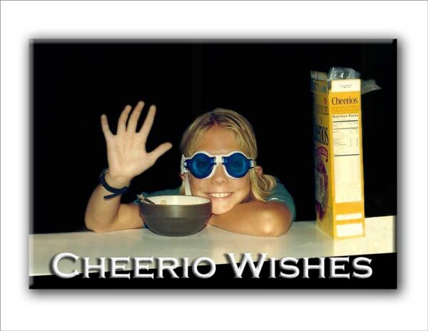 Photo of Young Girl in Swim Goggles at Counter With Cheerios Box